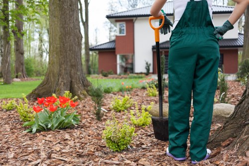 Garden maintenance crew performing seasonal pruning and lawn care